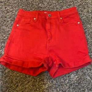 Red, high-waisted GUESS denim shorts